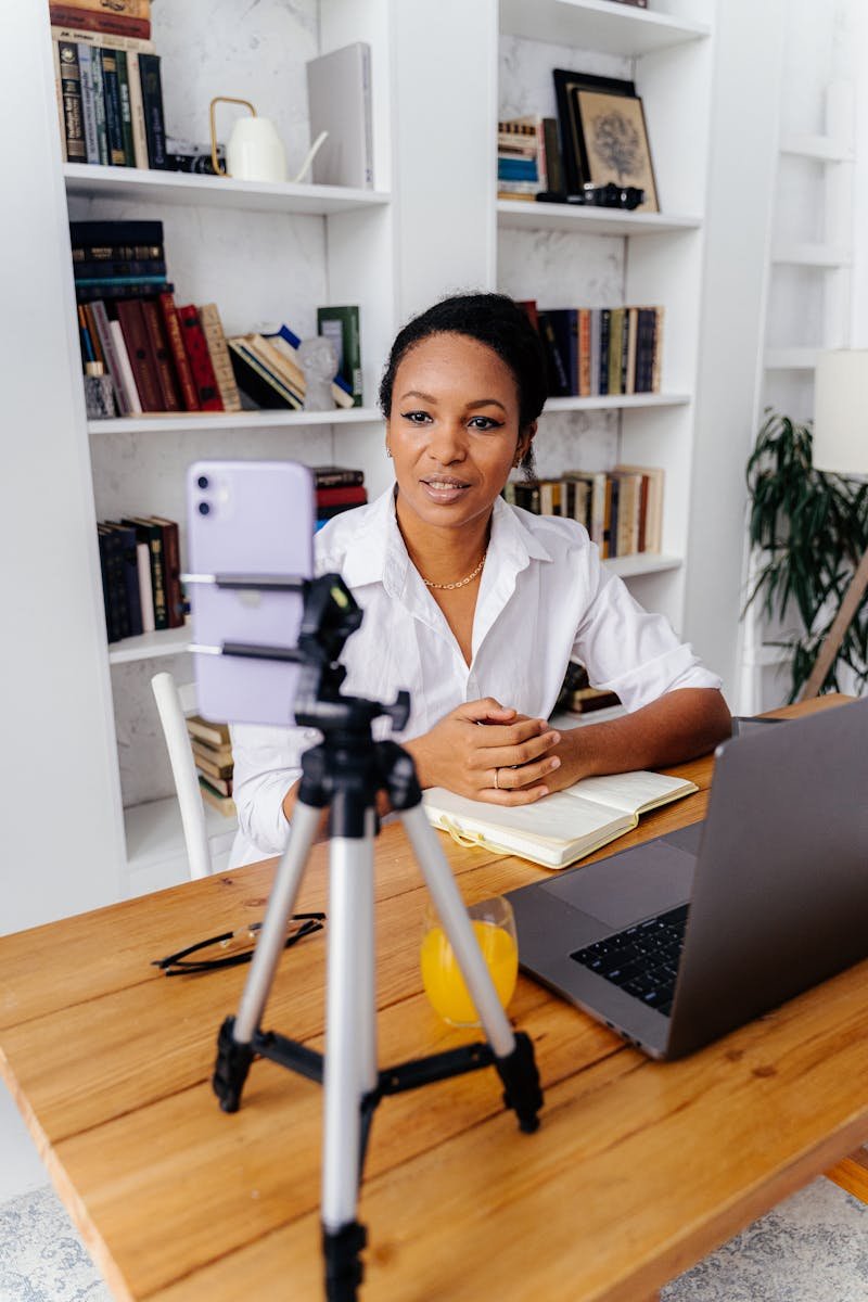 Woman Looking at Smartphone on Tripod